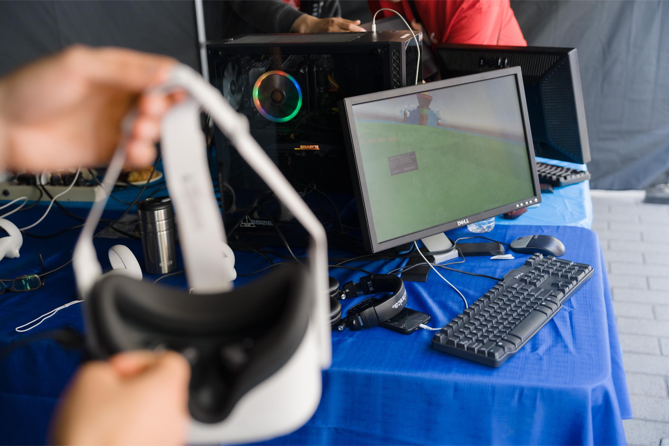 A computer and VR headset at the Virtual Reality Games Booth.